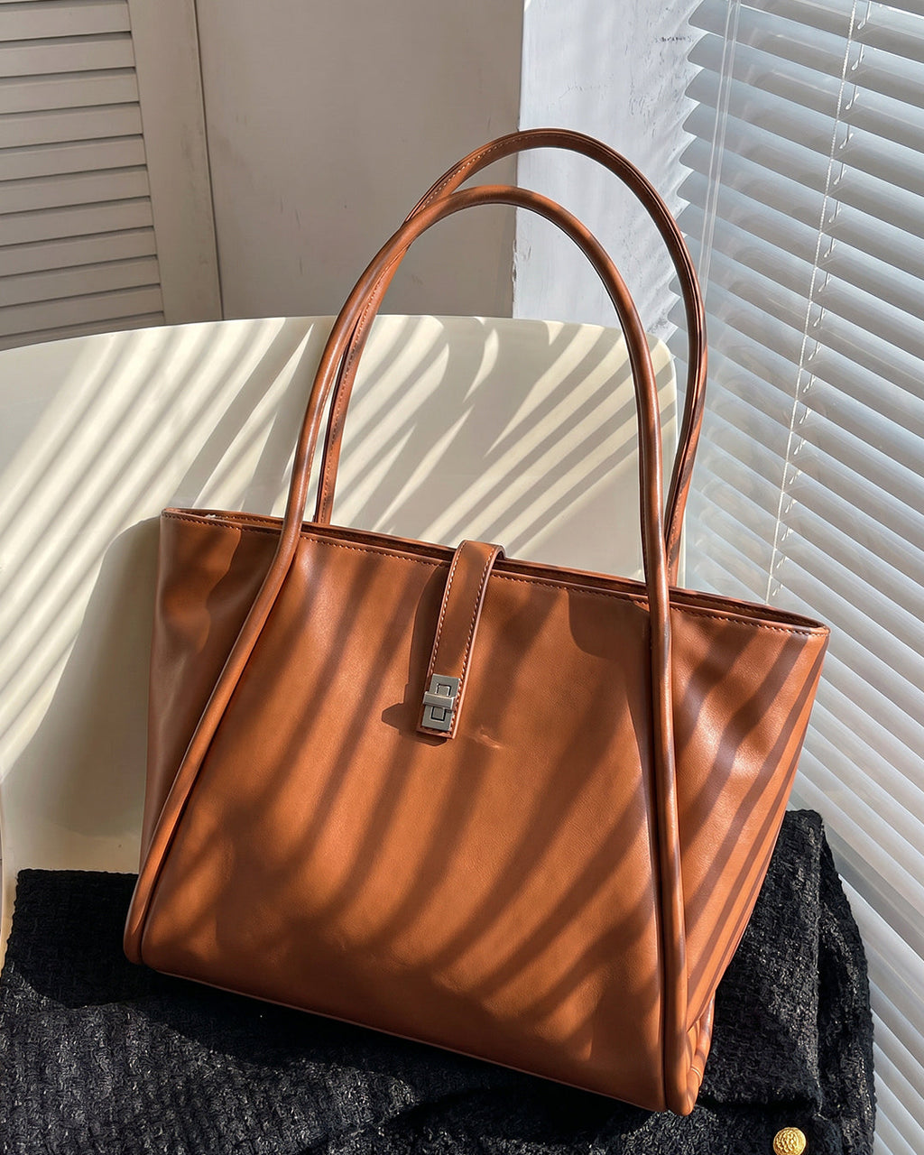 StyleShoot's Minimalist Turn Lock Tote Bag in Rust Brown