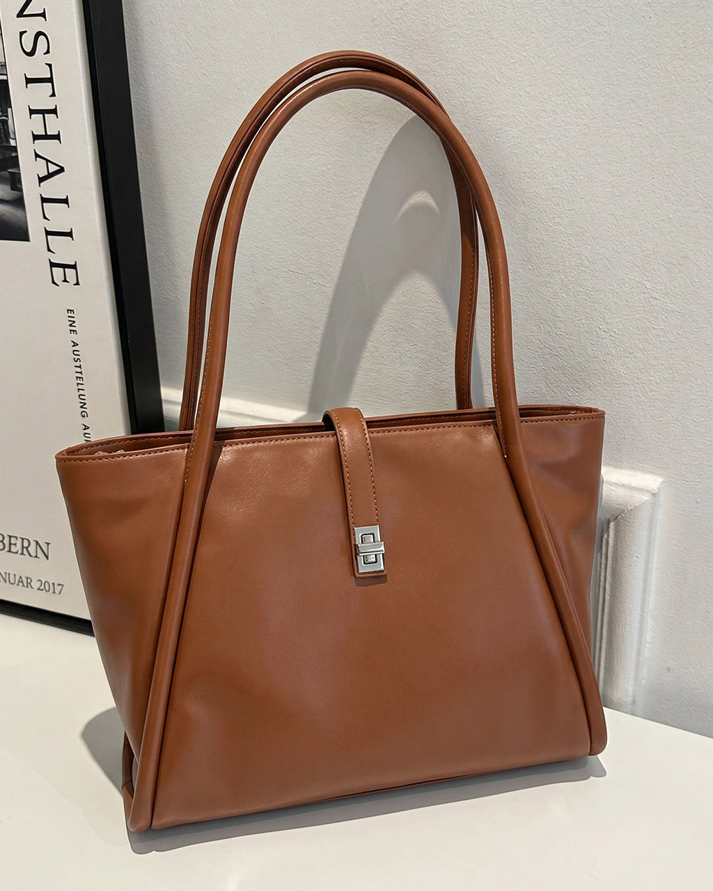 StyleShoot's Minimalist Turn Lock Tote Bag in Rust Brown